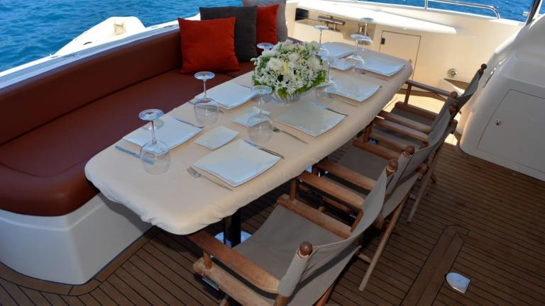 A table set on a yacht decorated with fresh flowers